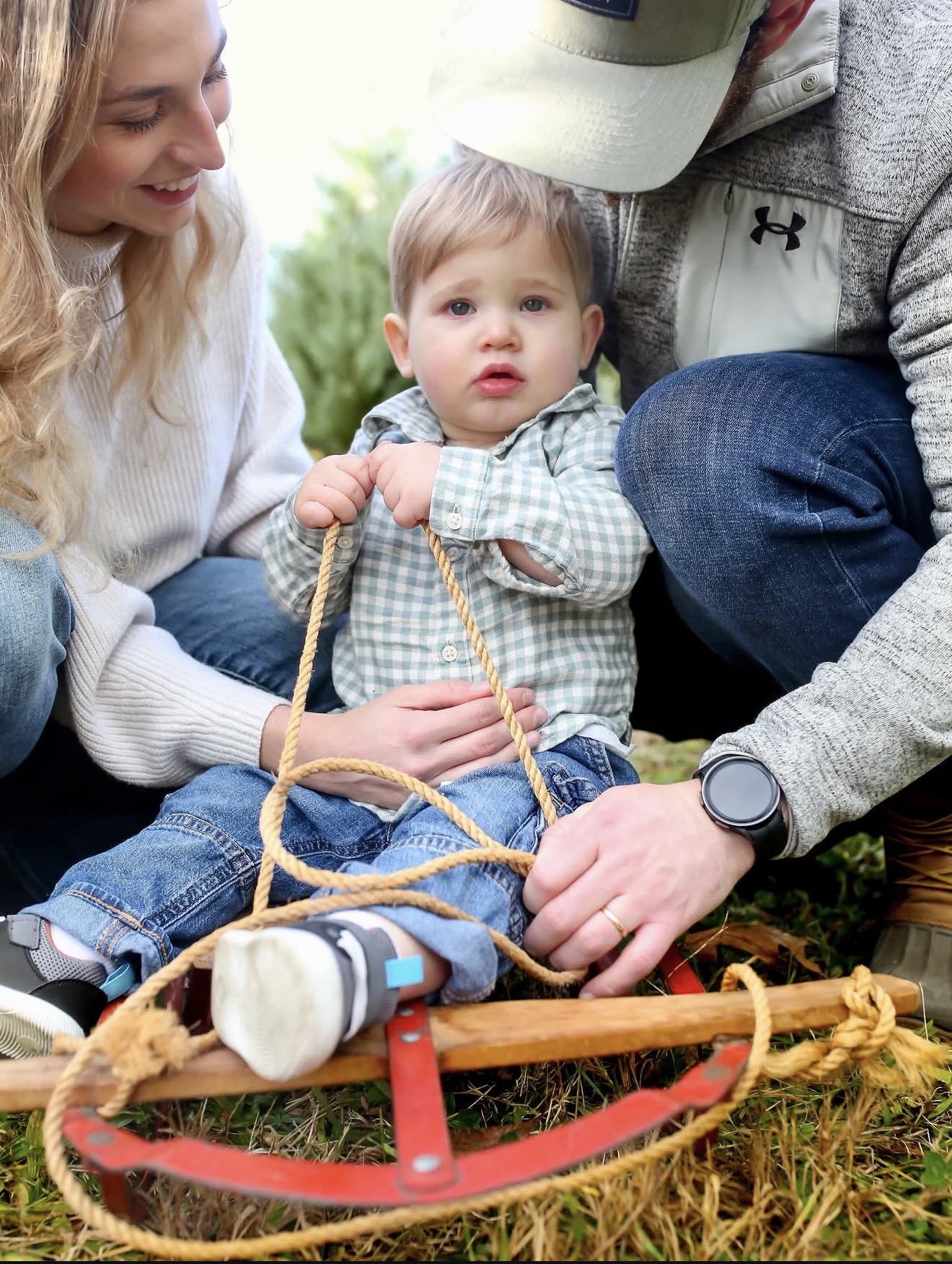 Baby photographed with family outdoors