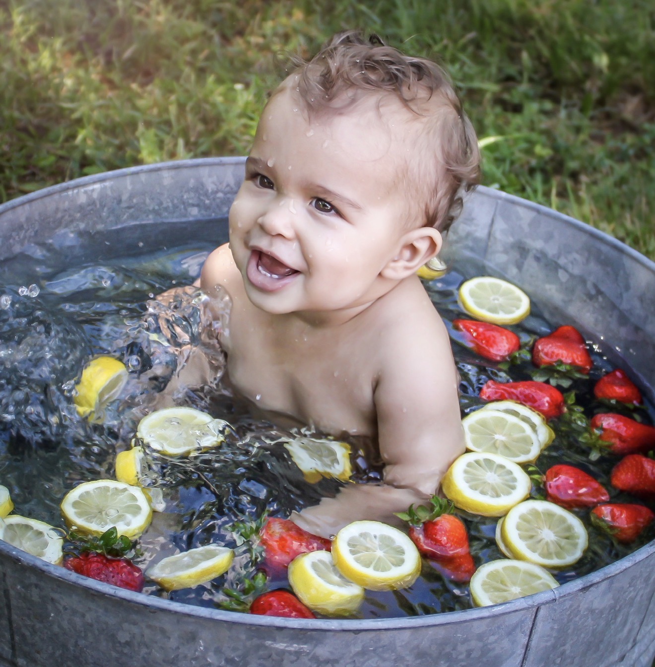 Baby enjoying a fruit bath portrait